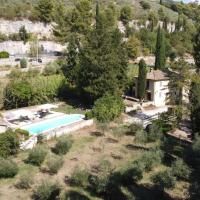 A picturesque scene of a villa with a pool, surrounded by trees and typical Umbria vegetation.