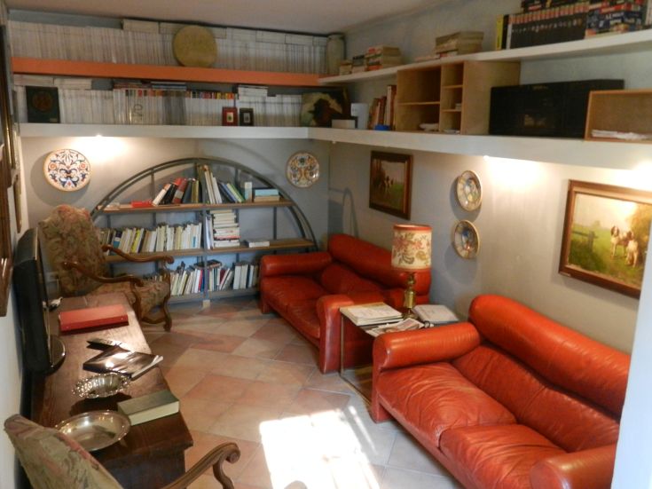 A simple living room with red sofas and bookshelves, providing a cozy and inviting space.