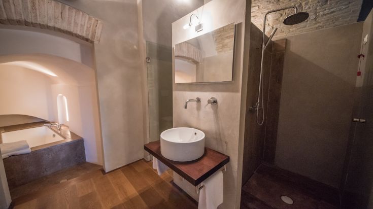 Modern bathroom with shower and tub, featuring a simple and functional design within an apartment.
