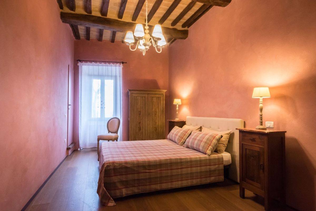 Cozy and simple room with pink walls and wooden accents.