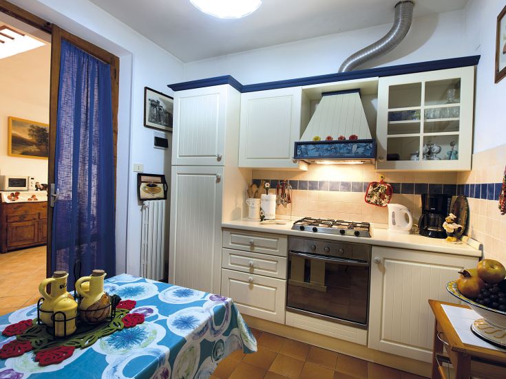 Bright and functional kitchen with modern appliances and simple yet well-designed furniture.