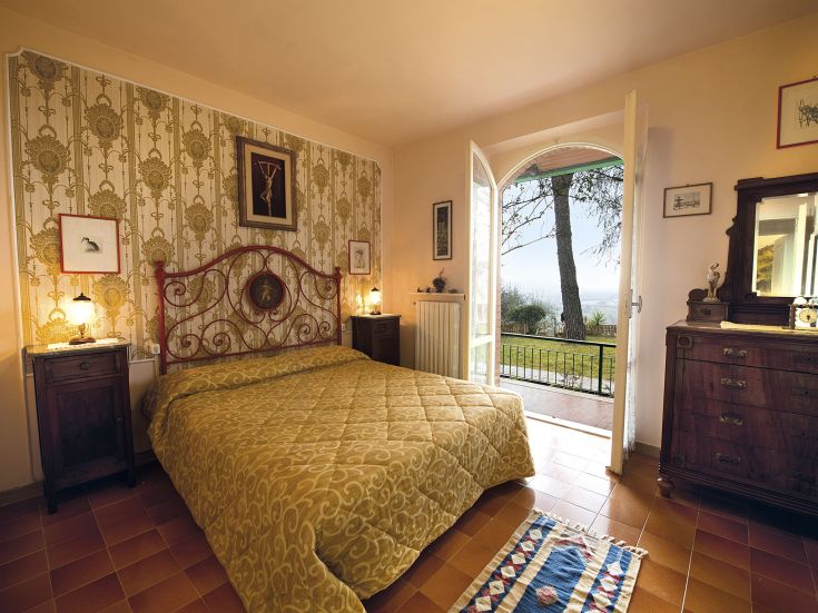 A peaceful room with a view of the surrounding greenery, perfect for a relaxing break in Umbria.