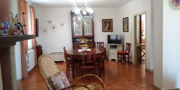 Spacious dining room with a wooden table and simple decor, perfect for family gatherings.