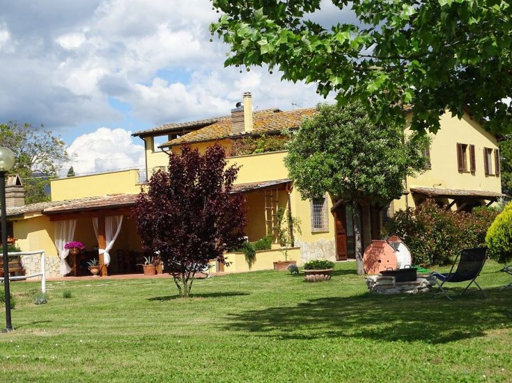 A building surrounded by greenery, featuring outdoor areas perfect for relaxation and small events.