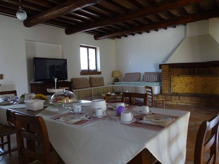 Cozy living room with rustic decor and a breakfast table set.