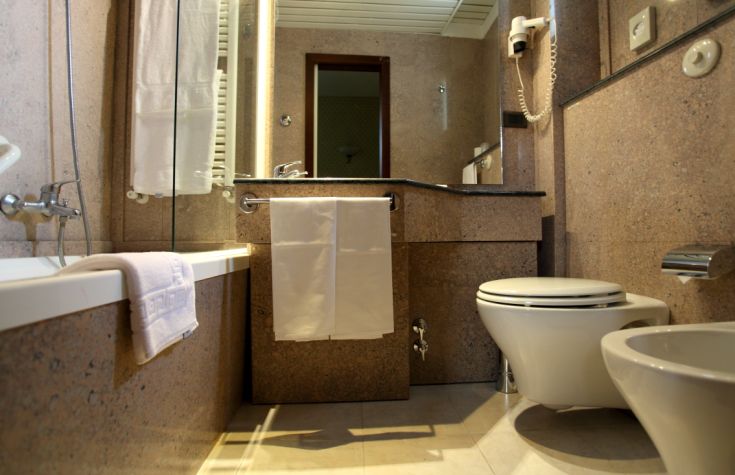 Inside a modern bathroom featuring a sink, bathtub, and contemporary fixtures.