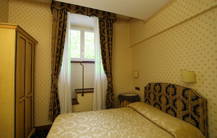 A cozy room with simple details and natural light streaming through the windows.