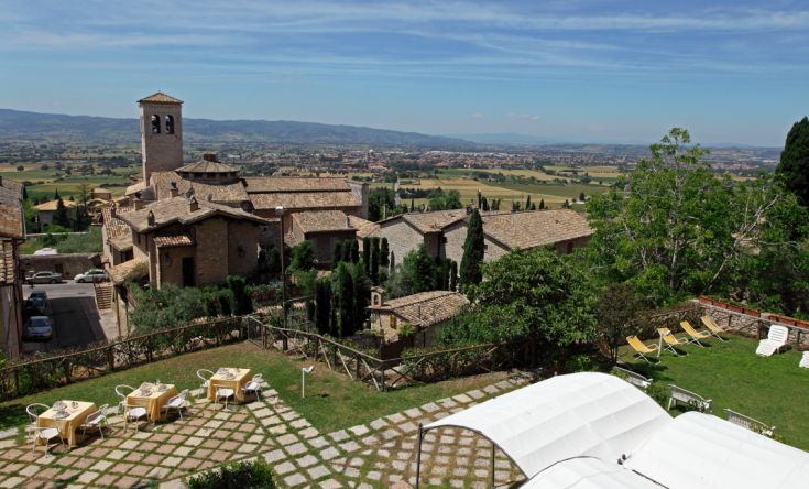 A serene natural scene featuring a historic village visible in the distance.