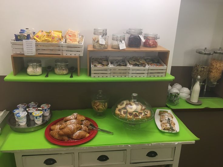 Hearty breakfast with pastries, yogurt, and cereals, perfect for starting the day balanced.