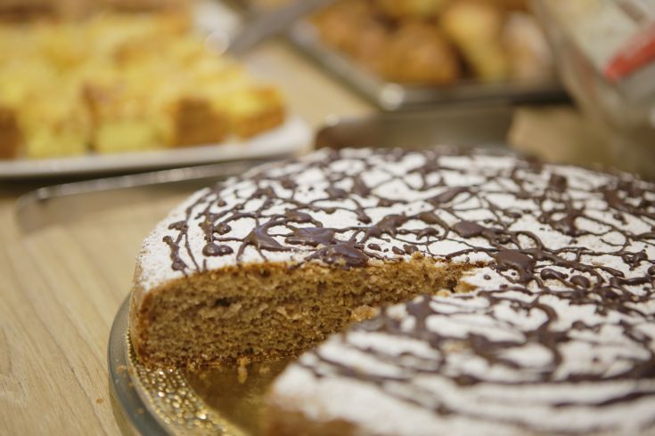 Torta al cioccolato ricoperta di zucchero a velo con decorazioni in cioccolato.