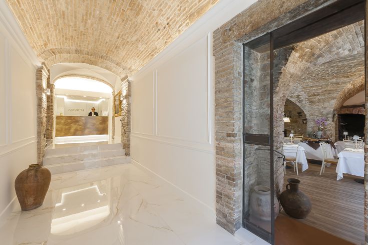 Entrance of the Palazzo Asisium Boutique Hotel, a blend of historical and modern elements in Assisi.