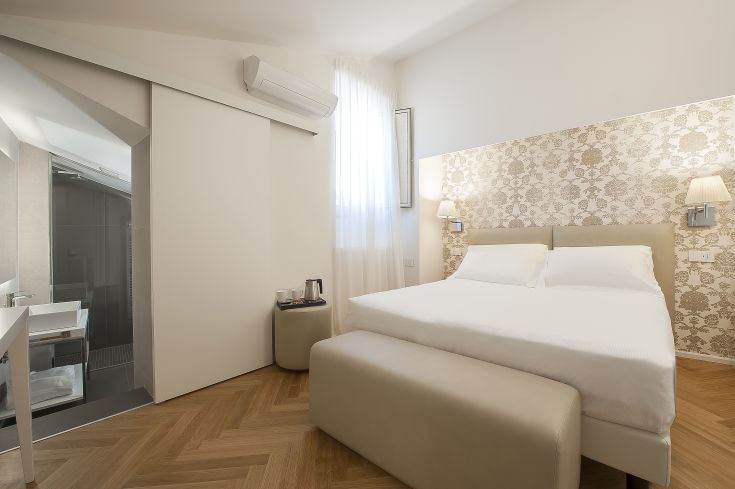 Quiet room in Asisium Boutique Hotel, featuring modern furnishings in a historic Umbrian building.