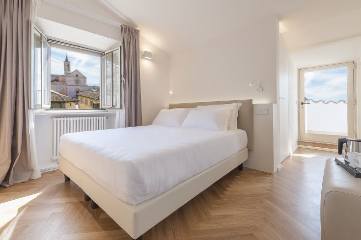 Contemporary room with a view of Assisi, perfect for a stylish historical getaway.
