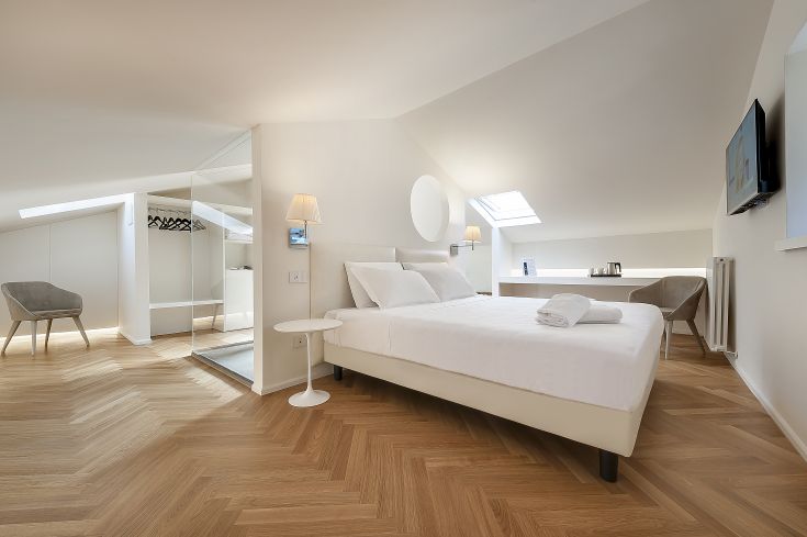 A simple and cozy hotel room featuring tidy furnishings and good lighting.