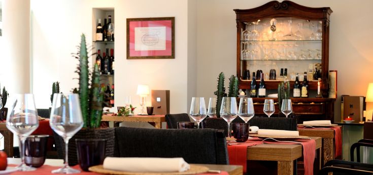 Restaurant located inside a hotel, featuring set tables and a calm atmosphere.