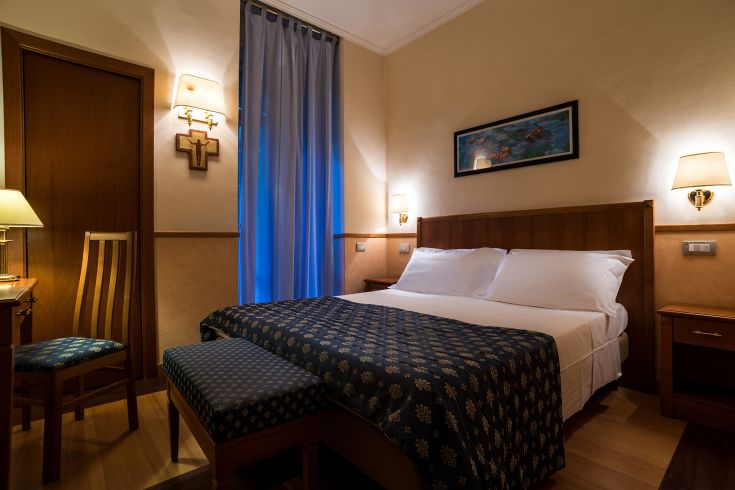 Spazio accogliente e luminoso con letto matrimoniale e mobili classici.