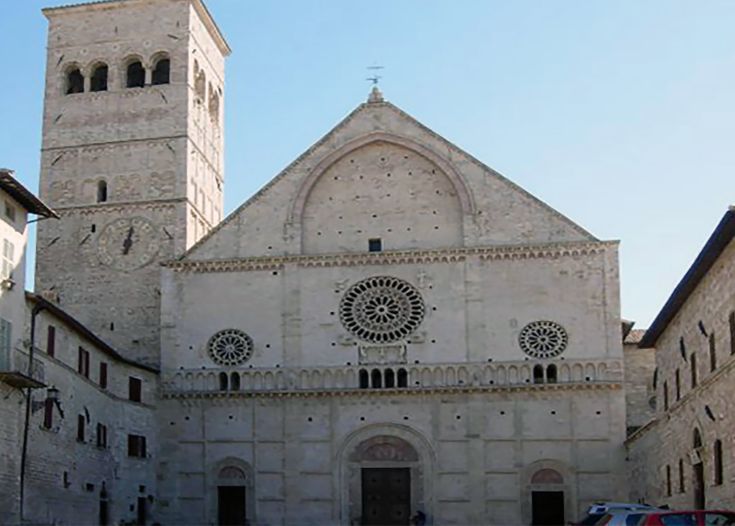 Facciata della Cattedrale di Assisi con elementi architettonici e il campanile ben visibile.