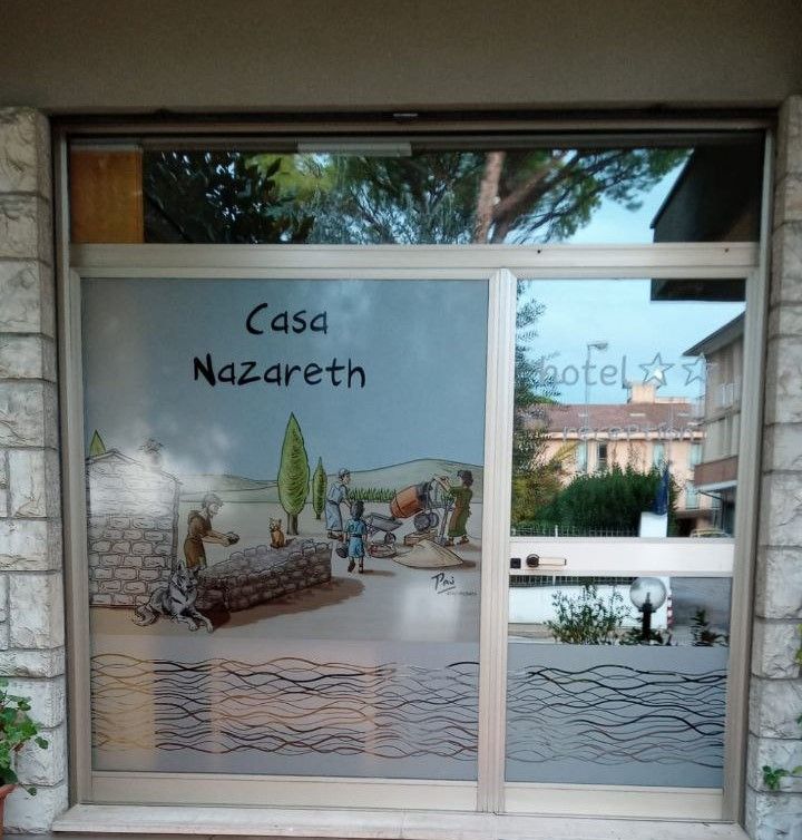 Welcoming building adorned with frescoes reflecting Franciscan tradition.