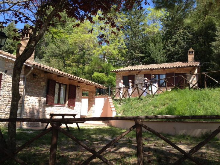 A cozy camping scene surrounded by greenery, featuring stone structures.