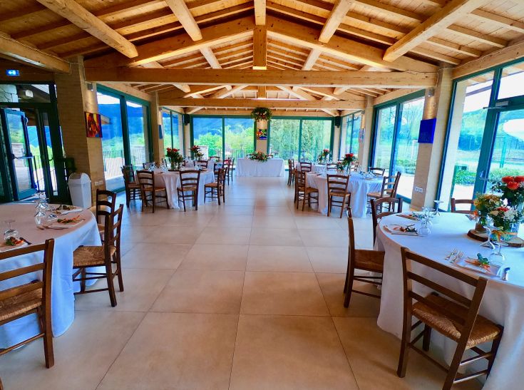 Un restaurant situé dans la nature, avec des tables bien disposées et un environnement magnifiquement soigné.