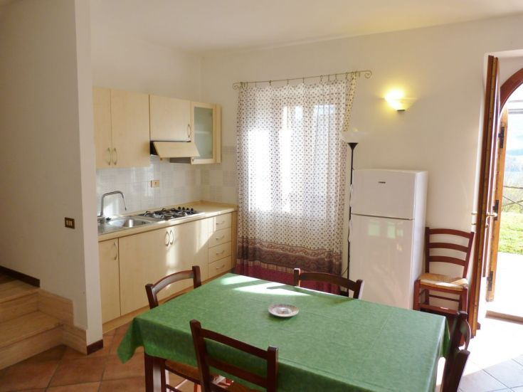 Spacious and inviting kitchen in a farmhouse, with a view of the surrounding countryside.