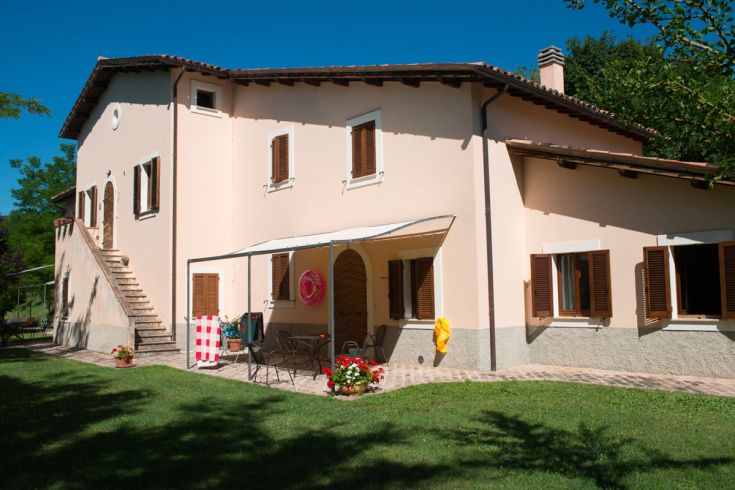 A cozy agriturismo surrounded by greenery, perfect for a nature getaway.