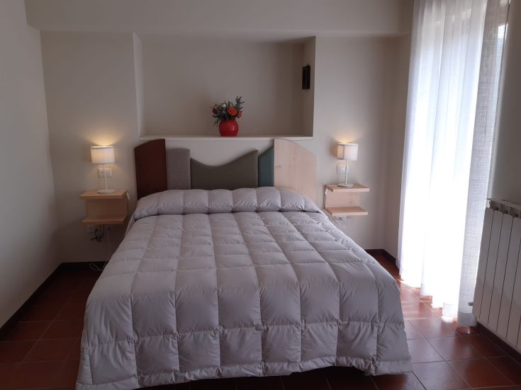 Bright and cozy room with comfortable beds, perfect for a peaceful stay.