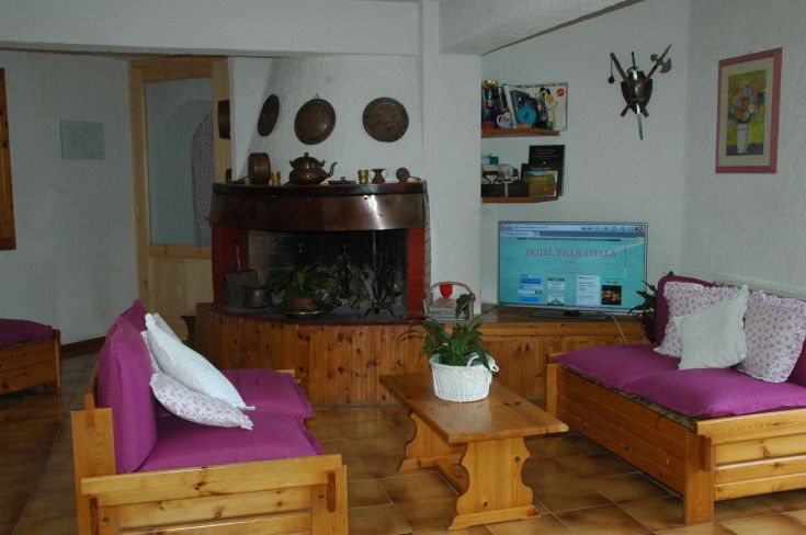 Stay at Villa Stella with comfortable wooden sofas and simple decorations.