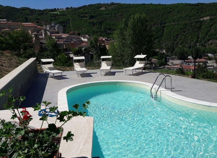 Private pool surrounded by greenery, with sunbeds available. A peaceful spot for relaxation.