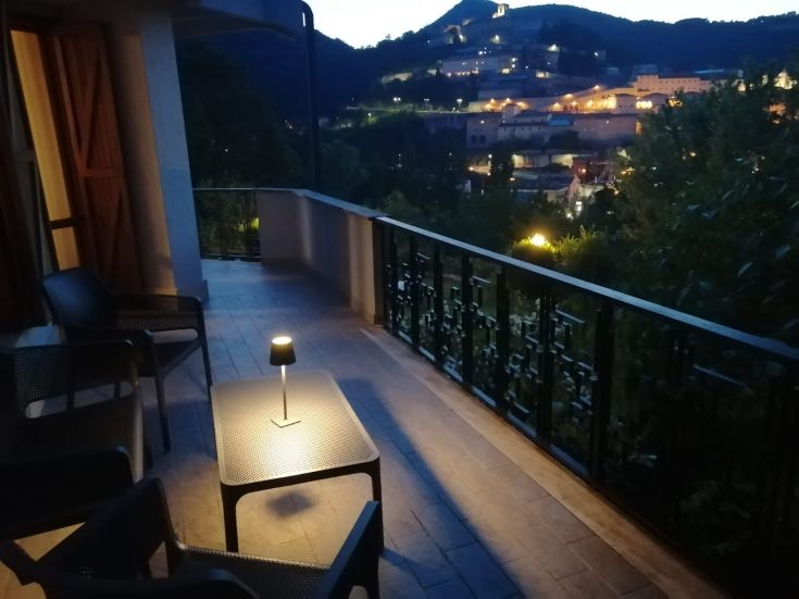 A relaxing corner of a hotel with a view of a beautiful night landscape. Calm and family-like atmosphere.