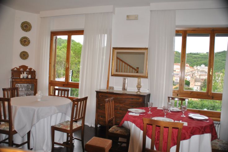 A cozy restaurant with arranged tables, large windows for views, and traditional details in the decor.