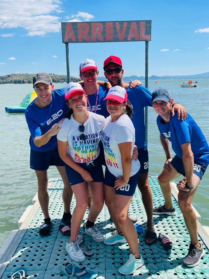 A group of smiling people at the dock, with a lively atmosphere and an 