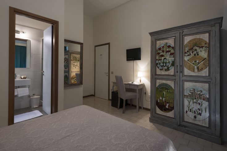 Camera luminosa con armadio e bagno privato, adatta per un soggiorno rilassante.