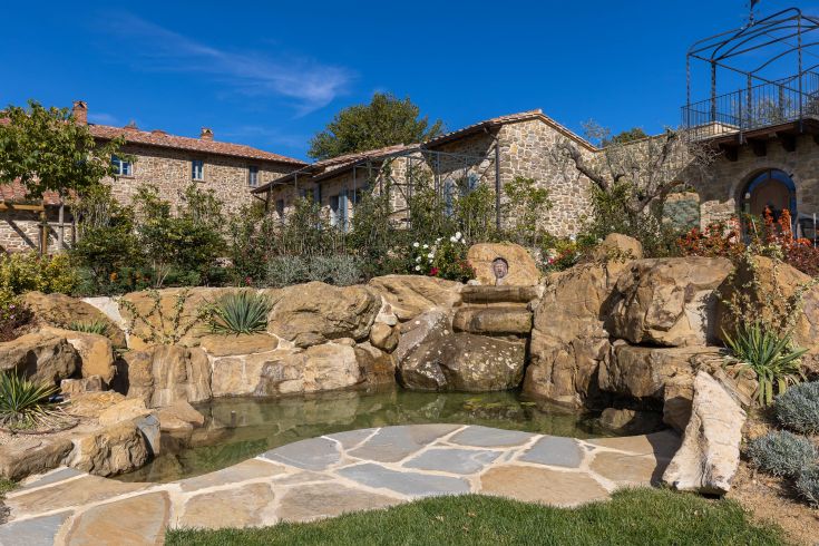 A picturesque corner of Umbria featuring well-maintained gardens and a serene view.