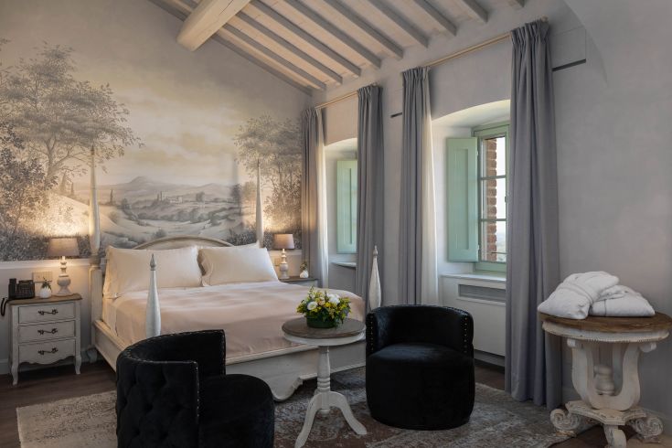 Simple bedroom with a view of natural surroundings, perfect for a relaxing break in Umbria.