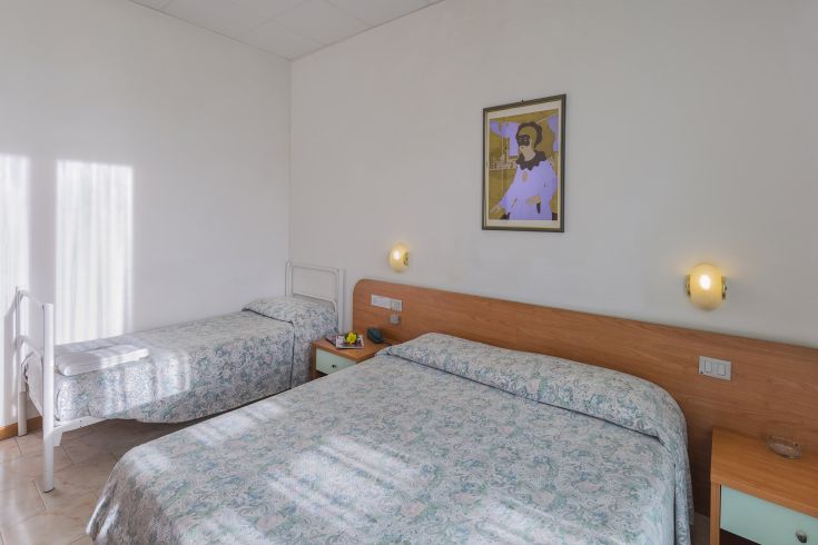 Cozy and functional hotel room with modern furniture and a calming atmosphere for relaxation.