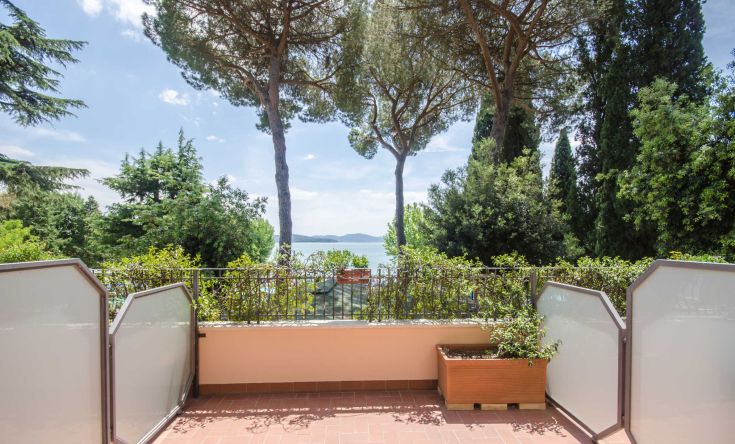 View from the terrace of Hotel Kursaal, surrounded by nature, overlooking Lake Trasimeno.