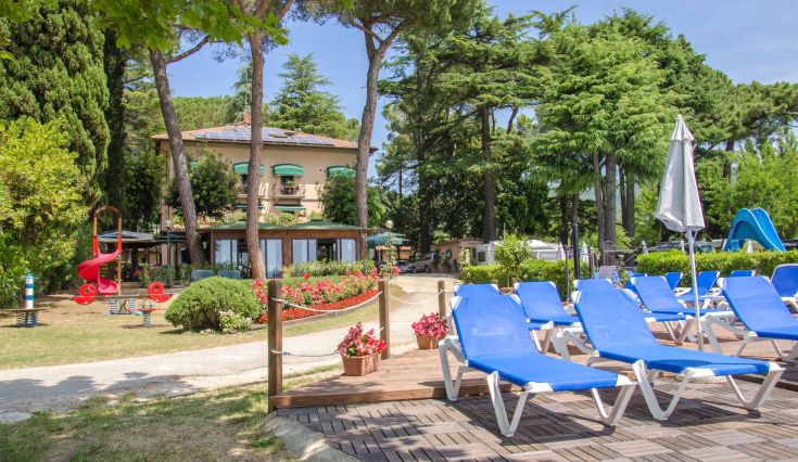Scene of the Kursaal Hotel surrounded by greenery, featuring a pool for guests to relax.