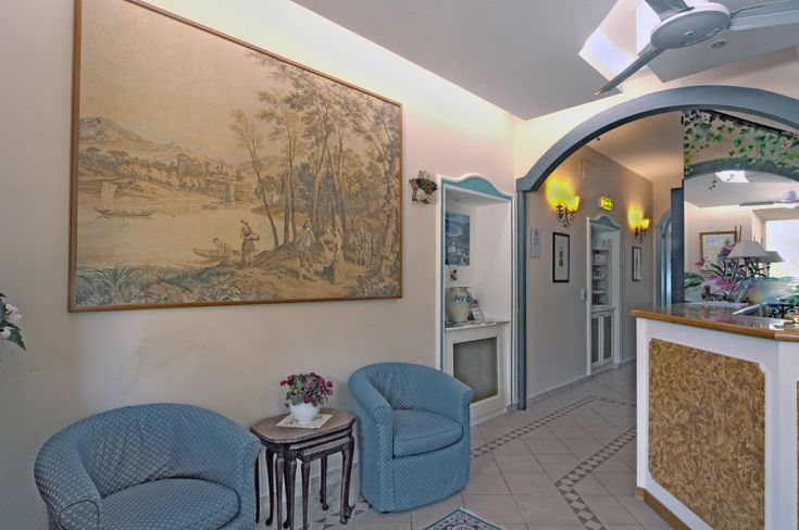 Hotel entrance with cozy furnishings and simple decorations, creating a relaxed atmosphere.