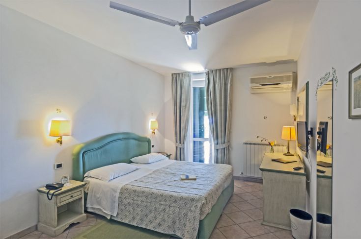 Cozy hotel room with comfortable beds and simple furnishings, perfect for a relaxing stay.