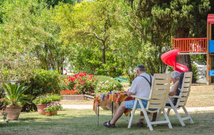 A cozy relaxation area in a campsite surrounded by trees and greenery. Perfect for a peaceful break.