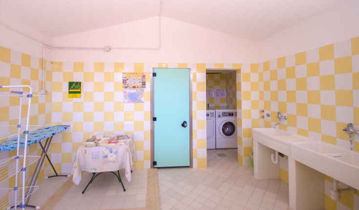 A laundry room equipped with a washing machine and dryer, featuring areas for washing and drying clothes.