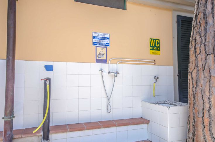 A designated outdoor camping area equipped with amenities like showers and toilets.