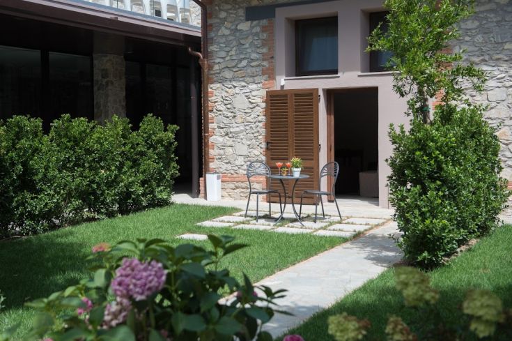 Ein einfacher Garten mit Tisch und Stühlen, ideal um ruhige Zeit im Freien zu verbringen.