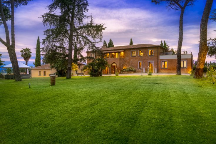 A countryside agriturismo surrounded by greenery, offering views of Umbria and Tuscany hills. Perfect for a serene getaway.