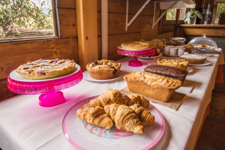 A variety of sweet treats arranged on a wooden table, perfect for a simple breakfast.