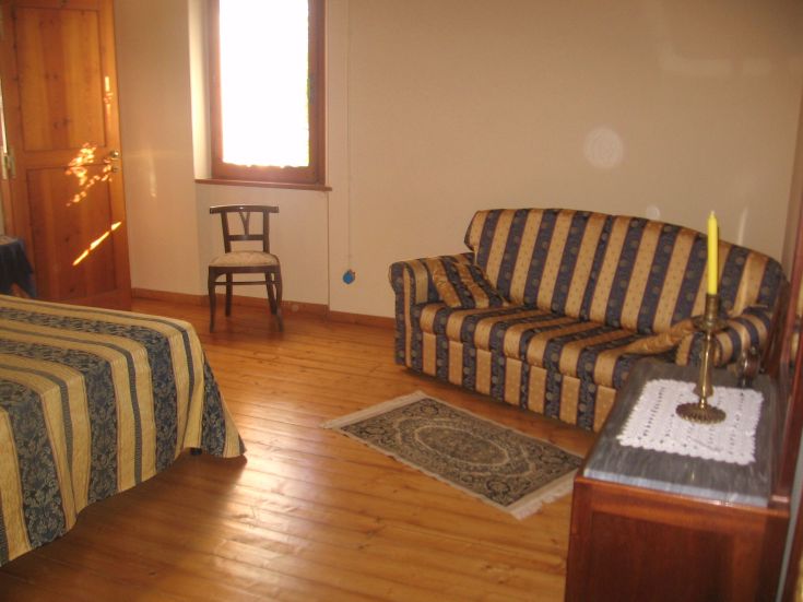 Geräumiges Zimmer mit rustikalen Elementen, perfekt für entspannende Momente in einer ruhigen Umgebung.