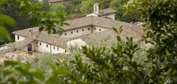 Un ancien monastère entouré de verdure, maintenant un hôtel tranquille proposant des services de bien-être.