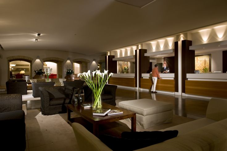Le hall de l'hôtel présente des meubles simples et un éclairage chaleureux, créant une atmosphère accueillante pour les clients.