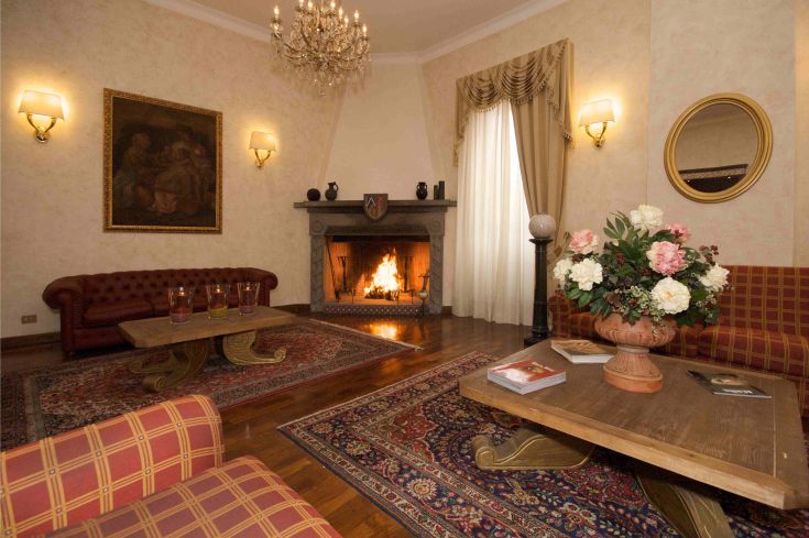 Una sala accogliente con camino e arredamenti semplici, ideale per momenti di relax.